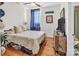 Cozy bedroom with hardwood floors and a window with blue curtains. Dartmouth Ave street sign on wall at 226 Magnolia Ave, Charlotte, NC 28203