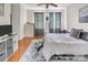 Bright bedroom features a ceiling fan, a cozy rug, dresser, and lots of natural light from the patio door at 226 Magnolia Ave, Charlotte, NC 28203