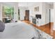 Bright bedroom featuring hardwood floors, a balcony view, and contemporary decor at 226 Magnolia Ave, Charlotte, NC 28203