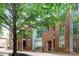Modern brick townhouse with large windows and mature trees surrounding the property at 226 Magnolia Ave, Charlotte, NC 28203