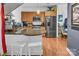 Modern kitchen with breakfast bar features stainless steel appliances, granite counters, and ample storage at 226 Magnolia Ave, Charlotte, NC 28203