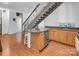 Modern kitchen with wood floors, stainless steel appliances, granite countertops and unique floating metal stairs at 226 Magnolia Ave, Charlotte, NC 28203