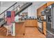 Modern kitchen features stainless appliances, granite countertops, and a breakfast bar under an open staircase at 226 Magnolia Ave, Charlotte, NC 28203
