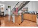Kitchen with island and stainless steel appliances, seamlessly flowing into the living area at 226 Magnolia Ave, Charlotte, NC 28203