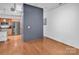 Bright living room features hardwood floors, open floor plan and stainless steel kitchen appliances in background at 226 Magnolia Ave, Charlotte, NC 28203