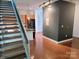 Open-concept living space with hardwood floors, kitchen, and modern staircase at 226 Magnolia Ave, Charlotte, NC 28203