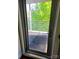 Sunlit patio view through glass door, showcasing outdoor space with gray pavers and metal railing at 226 Magnolia Ave, Charlotte, NC 28203
