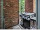 Cozy patio with brick wall, gas grill, and access to outdoor space perfect for relaxing or entertaining at 226 Magnolia Ave, Charlotte, NC 28203