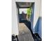 View of a patio with gray pavers, white walls, and metal railing with green foliage in the background at 226 Magnolia Ave, Charlotte, NC 28203