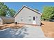 Rear view of the home with vinyl siding, a concrete patio, and a partially seeded backyard at 2506 Glendale Ave, Kannapolis, NC 28081