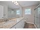 The bathroom boasts a double vanity, a large mirror, and a glass-enclosed shower for a luxurious feel at 2506 Glendale Ave, Kannapolis, NC 28081