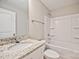 Bathroom featuring a granite countertop and shower-tub combo at 2506 Glendale Ave, Kannapolis, NC 28081