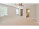 A bright bedroom with neutral walls and carpet, featuring a ceiling fan and two windows for natural light at 2506 Glendale Ave, Kannapolis, NC 28081