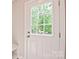 A white door with a window pane lets natural light into the home, with a mat just inside the door at 2506 Glendale Ave, Kannapolis, NC 28081