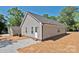 Gray house with a brick foundation, a paved walkway, and a yard with scattered straw at 2506 Glendale Ave, Kannapolis, NC 28081