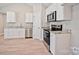 Open kitchen featuring white cabinets and stainless steel appliances at 2506 Glendale Ave, Kannapolis, NC 28081