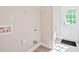 A well-lit laundry room with white walls and hookups for a washer and dryer, plus a door to the outside at 2506 Glendale Ave, Kannapolis, NC 28081