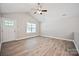 Bright living room with vaulted ceiling, wood-look floors, and fan at 2506 Glendale Ave, Kannapolis, NC 28081