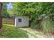 Backyard featuring a storage shed, grass, trees, and a wooden fence at 2617 Bay St, Charlotte, NC 28205