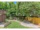 Landscaped backyard featuring a waterfall, grass, wood fence, and small garden at 2617 Bay St, Charlotte, NC 28205