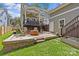 Spacious backyard with a stone patio, rocking chairs, and stairs leading to the covered porch at 2617 Bay St, Charlotte, NC 28205