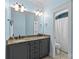 Bathroom with granite countertop vanity, double sinks, and a door leading to the toilet at 2617 Bay St, Charlotte, NC 28205