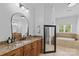 Spacious bathroom with granite countertop, dark wood cabinets, oval mirror and a soaking tub at 2617 Bay St, Charlotte, NC 28205