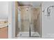 Bathroom with a glass shower enclosure and tiled walls at 2617 Bay St, Charlotte, NC 28205