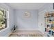 Inviting bedroom with a window and a shelf displaying books and decorative items at 2617 Bay St, Charlotte, NC 28205