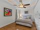 Bedroom boasts unique ceiling lighting, soft gray decor, hardwood floors, and stylish artwork at 2617 Bay St, Charlotte, NC 28205