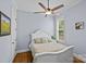 Comfortable bedroom features a white bed frame, plush pillows, ceiling fan, and a window view at 2617 Bay St, Charlotte, NC 28205