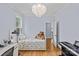Sunlit bedroom features a charming daybed, grand piano and a cozy teddy bear accent at 2617 Bay St, Charlotte, NC 28205