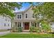 Inviting two-story home with a well-maintained yard, classic design, and a covered front porch with charming details at 2617 Bay St, Charlotte, NC 28205