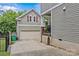Detached garage with upper level, accented by red shutters and a private entrance on the side at 2617 Bay St, Charlotte, NC 28205