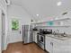 Efficient kitchen featuring stainless steel appliances, white cabinets, and a door to the outside at 2617 Bay St, Charlotte, NC 28205