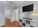 Cozy living room with entertainment center, lamps, and gleaming hardwood floors offers a warm ambiance at 2617 Bay St, Charlotte, NC 28205