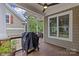 Covered porch featuring a BBQ grill and a view of the backyard's green lush landscaping at 2617 Bay St, Charlotte, NC 28205
