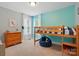 Bright bedroom with natural light, wooden bunk bed, and unique aqua accent wall at 2745 Stockwood Dr, Gastonia, NC 28056