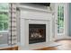A close up of the fireplace with white mantel and hearth with adjacent window at 2745 Stockwood Dr, Gastonia, NC 28056