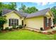 Close up of a cozy home with lush front lawn and manicured flowerbeds at 2745 Stockwood Dr, Gastonia, NC 28056