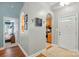 Inviting hallway with decorative arches leading to kitchen, bedroom, and front entrance at 2745 Stockwood Dr, Gastonia, NC 28056