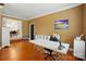 Well-lit living room featuring hardwood floors, an adjacent dining area, and neutral decor at 2745 Stockwood Dr, Gastonia, NC 28056