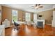 Spacious living room featuring hardwood floors, large windows, and a ceiling fan at 2745 Stockwood Dr, Gastonia, NC 28056