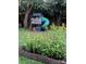 Picturesque backyard with a playhouse, flowers, and lush greenery, perfect for Gathering fun at 290 Union S St, Concord, NC 28025