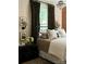 Serene bedroom with a brick wall, elegant chandelier, and plush bedding at 290 Union S St, Concord, NC 28025