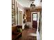 Stylish entryway featuring striped wallpaper, a vintage bench, and decorative hats, creating a welcoming ambiance at 290 Union S St, Concord, NC 28025