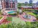 Condo featuring manicured gardens with a pool, fountain, and outdoor gathering spaces at 300 W 5Th St # 404, Charlotte, NC 28202