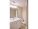 Bathroom featuring a vanity with drawers, large mirror, and a shower with neutral tile at 300 W 5Th St # 404, Charlotte, NC 28202