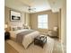 Cozy bedroom with neutral tones, ceiling fan, and a comfortable sitting area at 300 W 5Th St # 404, Charlotte, NC 28202