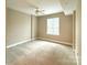 Neutral bedroom featuring plush carpeting, a ceiling fan, and a sunlit window at 300 W 5Th St # 404, Charlotte, NC 28202